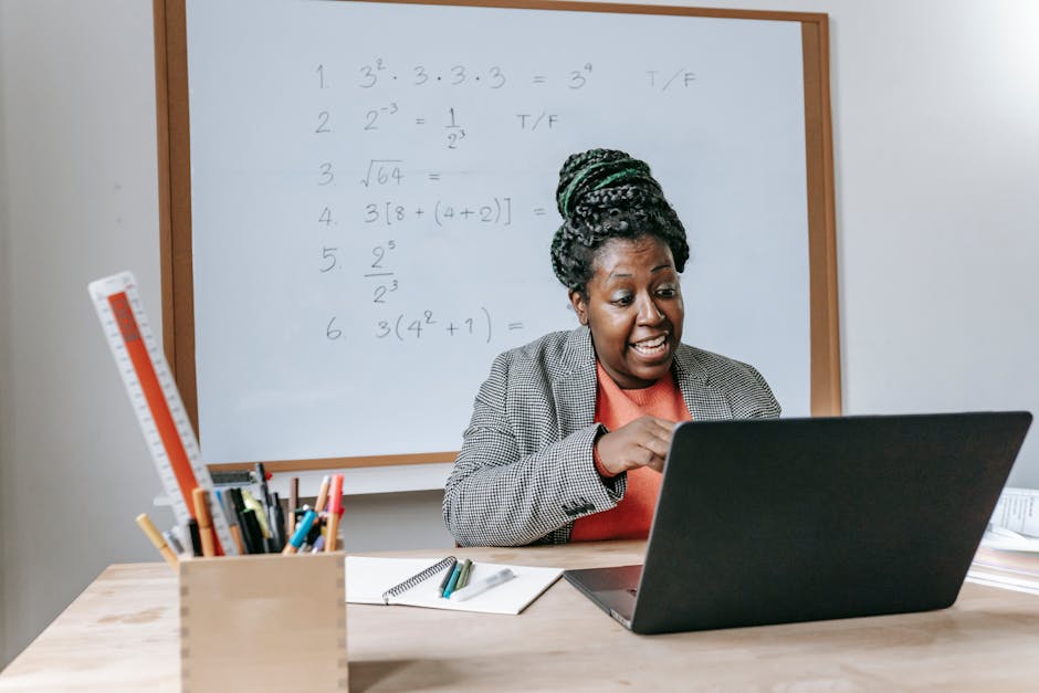 Amazed African American female giving lecture in mathematics online on netbook in classroom